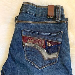 Odyn button fly medium to dark tone jeans